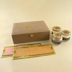 A sophisticated invitation box in a suede-finish material with a custom gold-plated name logo. This premium option includes multiple inserts and jars, offering a complete and luxurious gifting experience for your guests.