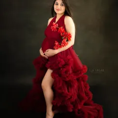 A bold and beautiful maternity portrait. This mom-to-be looks stunning in a flowing red gown from my studio collection, creating a dramatic and elegant look.
