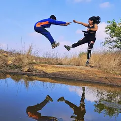 Who says you can't have a little fun on the trail? A perfectly timed action shot with a stunning reflection at Kaiwara Betta, capturing the playful spirit of our treks.