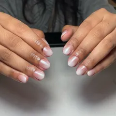 The "glazed donut" or "lip gloss" nail trend is perfect for a minimalist bride. It's a sheer, milky white ombré on short, natural nails that looks clean, healthy, and incredibly chic.