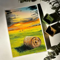 A beautiful gouache painting of a haystack in a field under a dramatic sunset. The shadows and light in this piece create a really peaceful, rustic feeling.