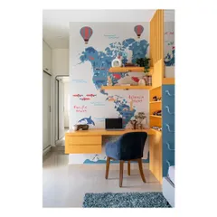The study area in the children's room, seamlessly integrated with the bunk bed structure and world map wallpaper. The design provides a comfy and inspiring spot for learning and creativity.