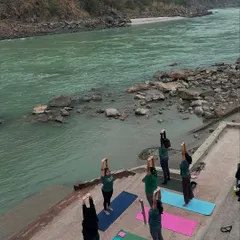 From a bird's eye view, our tribe salutes the sun on the banks of the holy Ganga. Practicing yoga in Rishikesh, surrounded by the tranquil sounds of the river and fresh mountain air, is an experience that rejuvenates the body and soul.