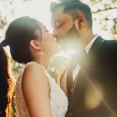 Bathed in the soft glow of the golden hour, this intimate kiss captures the pure connection between the couple. I focus on finding the perfect natural light to create a warm, dreamy atmosphere, allowing your natural chemistry to shine without forced poses. This is a perfect example of a candid NRI couple portrait.