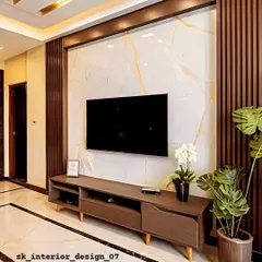 This TV unit combines a marble back panel with dark fluted wood columns. The simple, low-profile console provides storage, while the large plant adds a touch of nature to the modern design.