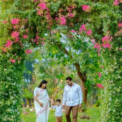 A simple walk together can create the most beautiful memories. We captured this family strolling hand in hand under a lush green arch, showcasing a natural, candid moment that tells a story of connection and togetherness.