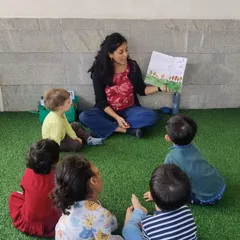 I often take story time outdoors to our green space. Reading to a small group in a natural setting is a wonderful way to capture their attention and connect stories to the world around them.