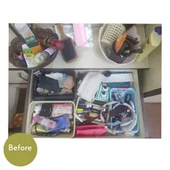 The "before" of a dressing table area. Drawers are overflowing with cosmetics, and the countertop is cluttered with brushes and products.