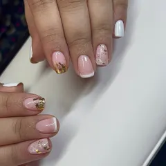 A mixed-style set featuring a classic French tip alongside white and gold foil nails.