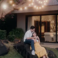 A magical evening portrait under a tree adorned with fairy lights. This setup creates an incredibly romantic and dreamlike atmosphere for a pre-wedding shoot.