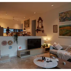 The same view at night, where warm artificial lighting creates a cozy and intimate atmosphere. The home transforms from a bright, airy space by day to a tranquil retreat by night.