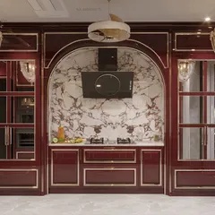 We transformed this culinary space into a masterpiece with a stunning maroon color palette and classical design elements. The arched marble backsplash serves as a grand focal point for the cooking area.