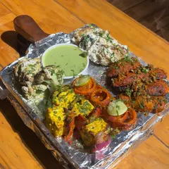 Get a taste of our kitchen's best with this sizzling tandoori platter. It’s packed with a variety of paneer tikka, malai broccoli, and soya chaap, all grilled to perfection in our tandoor.