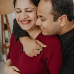 The pure joy of anticipation captured in a candid moment. This close-up from a lifestyle maternity session highlights the genuine laughter and affection between the couple, showing that the most beautiful portraits are often the unposed ones.
