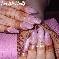 A soft and shimmery pink glitter nail set, perfect for complementing intricate bridal mehendi designs.