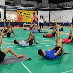 A strong body and a focused mind are inseparable. Here, our athletes engage in a guided stretching session, part of our integrated yoga program designed to improve flexibility, prevent injuries, and enhance on-court performance.