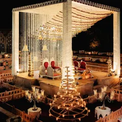 The magnificent mandap setup for a Royal Marwar wedding at Suryagarh. The multi-level design, surrounded by candles, was inspired by the region's traditional step-wells.