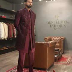 A formal pose showcasing the complete wine-colored Indo-western outfit. The coordinated kurta, trousers, and jacket create a cohesive and luxurious look suitable for any grand celebration.