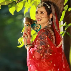 Capturing candid, happy moments is just as important as the posed shots. This image from our Heeramandi-style shoot shows the model's joyful expression, highlighted by the soft, natural light filtering through the leaves.
