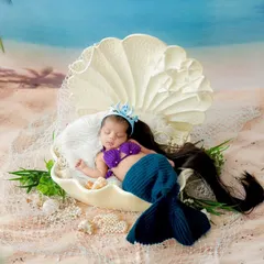 A little mermaid dreaming of the sea. I use creative props and costumes to bring fairytale concepts to life for newborn photoshoots.