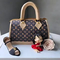 A chic Louis Vuitton handbag cake. This sculpted cake, complete with the LV monogram, is perfect for the fashion lover in your life.