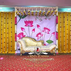 A unique and artistic backdrop for a baby shower. This stage setup features a hand-painted lotus theme, complemented by a regal chaise lounge for the mother-to-be.