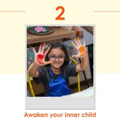 A young girl shows her paint-covered hands to the camera, a perfect picture of the "awaken your inner child" spirit of my workshops.