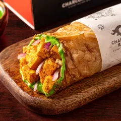 This paneer tikka roll for Charcoal Eats is styled to look hearty and delicious. The clean, focused shot highlights the texture of the paratha and the generous filling, making it an ideal image for a delivery menu.