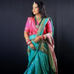 This image showcases a complete traditional bridal look, with hair styled to accommodate the saree and jewelry. Our courses cover how to create cohesive and culturally appropriate looks for brides.