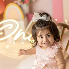 A pretty princess, so energetic and sweet. Her smile lights up this entire colorful first birthday setup.
