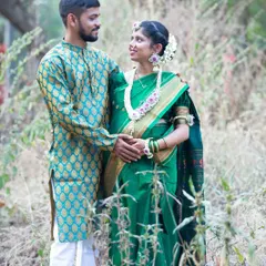 A loving couple's portrait during their baby shower festivities. Dressed in beautiful traditional attire, their shared glance is full of love and excitement for their baby's arrival.