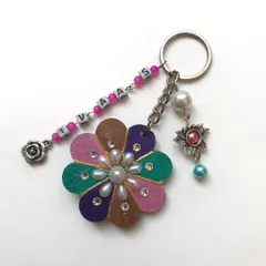 I love making these personalised keychains with extra flair. This one has a hand-painted flower base, a beaded name chain, and multiple charms like a pearl and a little rose for a layered look.