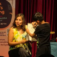 I love it when kids get to be part of the act. Here, a young volunteer helps me create a new character right on stage.