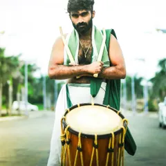 A powerful stance, holding the tools of his art. This portrait captures the intensity and pride of our artists.