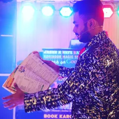 On stage and ready to amaze. This shot captures a moment from one of our stage shows, where we perform larger illusions like this book trick for a captivated audience.
