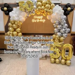 Celebrating 50 years in style with this gold, silver, and black balloon arch. The large foil numbers and neon "Happy Birthday" sign make this a perfect setup for a milestone celebration.
