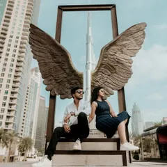 A creative and iconic pre-wedding shot at the Wings of Mexico sculpture with the Burj Khalifa perfectly framed. This is a must-have photo for any Dubai love story.