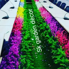 A unique conference table with a built-in artificial garden running down the center. This design uses a variety of colorful plants to create a one-of-a-kind centerpiece.