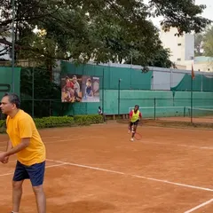 A doubles team in action during a TTPL event. You can see the ample space and well-maintained surroundings that make our courts ideal for tournaments.