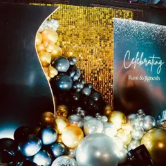 This modern backdrop combines a gold shimmer wall with an organic balloon garland in metallic tones. It's a versatile setup that works well for product launches, company parties, or award night photo booths, offering a touch of glamour.