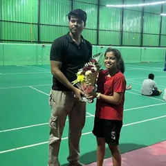 A student presenting a bouquet during our 4th-anniversary celebration. The support from our players and their families is the backbone of our academy.