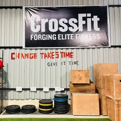 Change takes time, give it time. This message on our wall is a core part of our philosophy. You can also see our plyometric boxes and bumper plates, ready for the next workout.