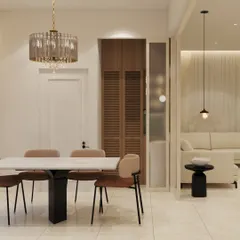 The dining area of "The Beige House" features a modern marble-top table and a crystal chandelier. The design uses a neutral palette with wooden accents in the crockery unit to create a warm and sophisticated space for family meals.