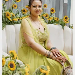 A portrait of a guest or family member enjoying the Mehendi ceremony, surrounded by a beautiful sunflower decor.
