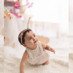 Capturing the crawling milestone. This baby looks up with a curious and sweet expression, perfectly showcasing this active and adorable stage.
