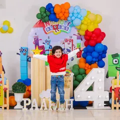 Pure joy in mid-air! We love capturing the energy of a party, like this little one jumping for joy at his action-packed Numberblocks themed 4th birthday. This setup included character cutouts, a colorful balloon arch, and a large light-up number four.