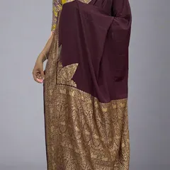 A full view of our restocked dark brown Banarasi saree. The rich, deep color paired with the golden paisley border creates a timeless and regal look. It’s shown here with a contrasting floral blouse.