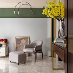 The view from the doorway into the green-accented bedroom, showing how the color blocking on the wall creates a sophisticated and modern architectural feature.