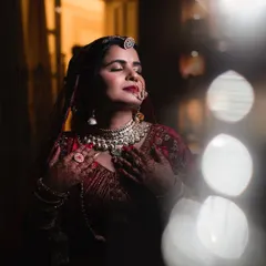 An artistic bridal portrait capturing a moment of serene beauty. I used soft lighting and a shallow depth of field to create a dreamy, ethereal feel, highlighting the bride's intricate jewelry and peaceful expression.