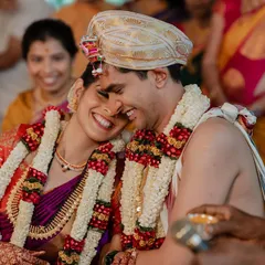 When you're truly in love, it shows. This candid shot captures a moment of pure, uninhibited laughter and affection between the couple during their ceremony.